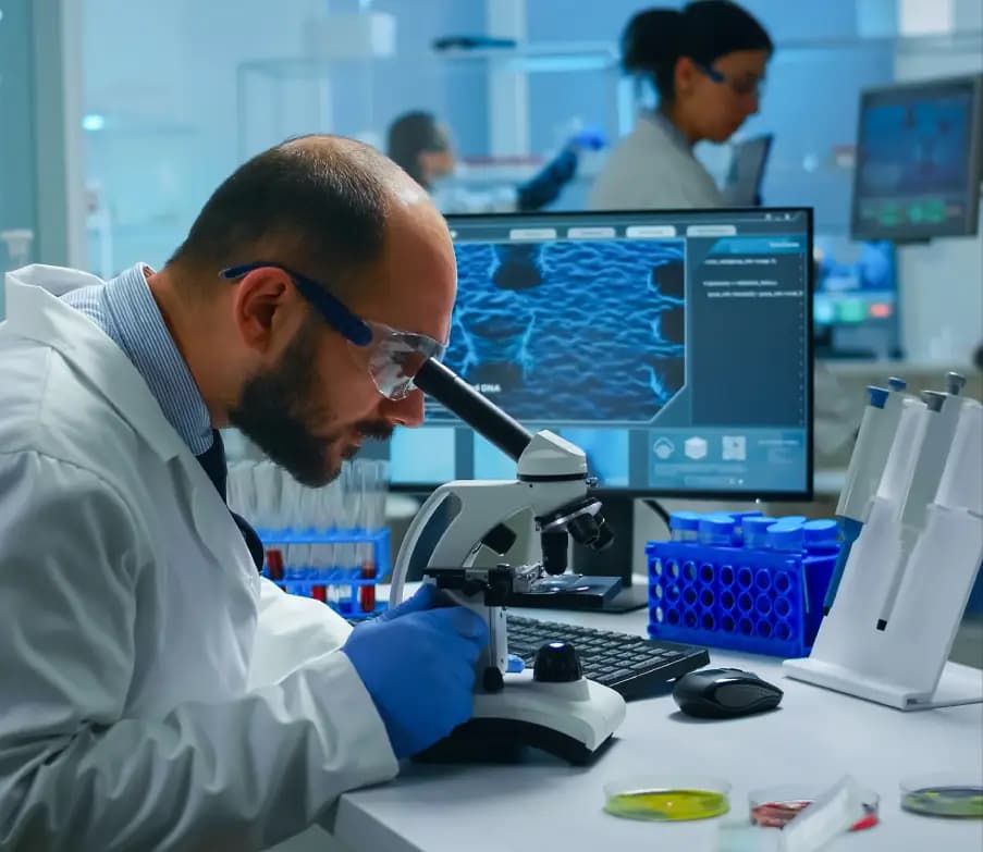 Scientist using microscope in research and testing laboratory